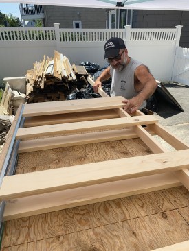 After ripping a 1x4 to width to match the pocket-door unit’s existing jamb, the author inserted the ripping into the frame and oriented it on the layout marks on the header and the horizontal blocking.