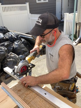 After flipping the unit over and completing the cut on the other side, he cut 8 inches off the aluminum track.