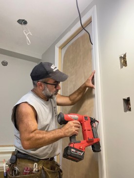 For perfect miter joints, he preassembled the door casings and installed them as units.