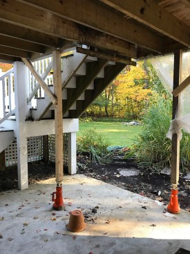 Water damage is clearly visible on the built-up support beam underneath the guard posts at the top of the stairs.