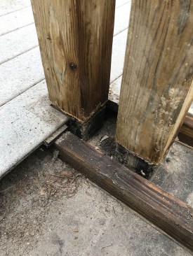 The porch decking was fastened to sleepers laid across a membrane-covered plywood roof deck. The posts were flashed to the membrane, but there was no counterflashing.