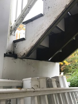 These stair stringers don't have adequate bearing on the landing. The landing will need to be enlarged, and the stringers replaced.