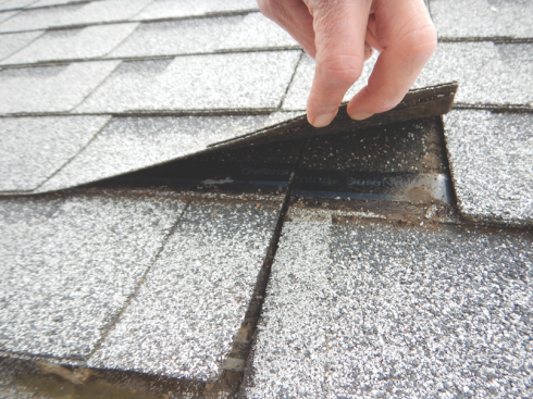 Shingle nailing. Shingles must be nailed at the ends, which did not happen in the roof pictured.