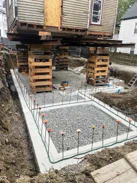 Once the footing had been poured, the site work contractor placed the subslab stone level to the tops of the footing before the foundation walls were formed and poured.