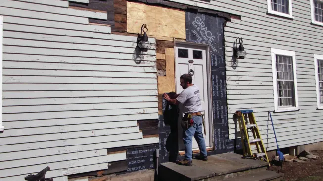 I loosened the clapboard siding around the door, removing any that had cracked or rotted, and patching in pieces of new sheathing where the old had to be replaced.