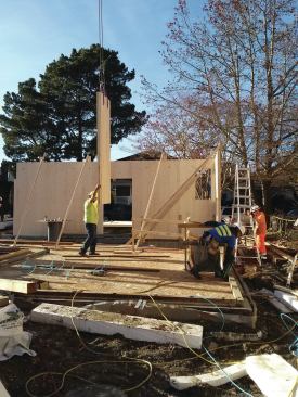 Panels were craned into place. Lifting straps were run through holes drilled near the tops of the wall panels.