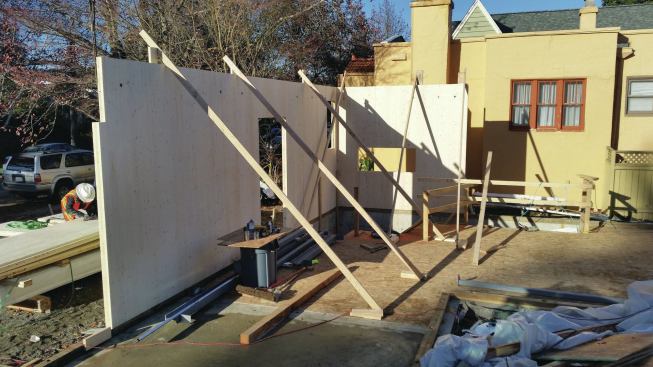 Wall panels were stood in place on the sills and held plumb with diagonal bracing—just like a stick-framed wall.