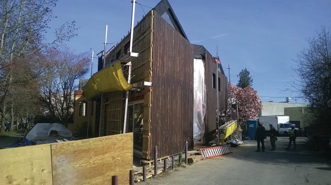 The exterior was insulated with rigid mineral panels and covered with vertical wood siding. Any types of rigid insulation and siding could have been used, however.