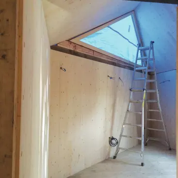 Outdoor-rated wiring was attached to the panel exteriors, then drilled through to the inside at each fixture location. Plumbing was routed through interior framed partitions and chases.
