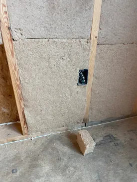 The batt with the cut-out is fit around the box, leaving behind only a box-sized piece of scrap.