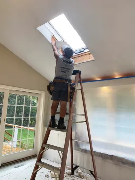 Before removing the drywall around the rough openings, I sealed off the wall and floor with plastic to catch the dust and debris.