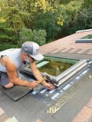 The Roto windows had been fastened to the roof with a few screws driven through angle brackets; the new, Velux skylights are fastened to the roof sheathing with 1 1/4‑inch roofing nails (included with the installation kit) driven through pre-punched holes in the units’ aluminum mounting flanges.
