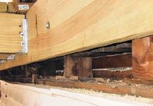 Figure 2. Required flashing and sheathing behind the deck ledger are missing, and the bolting schedule appears to be inadequate.