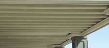 UnderDeck’s vinyl panels arch between the joists and drain to troughs that run the length of the joists into a gutter.