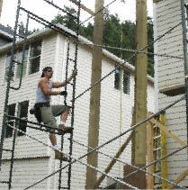 The crane lightened the burden, but still the author had to rig the bundles of lumber on the ground and climb the scaffold to guide them into place.