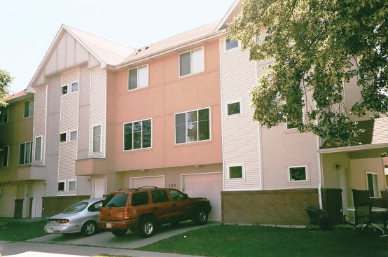 In this four-plex, each apartment is a vertical unit with its own street entrance, which eliminates upstairs neighbors and simplifies fire-barrier and sound-control details. The apartments have separate laundry facilities and garages, making them attractive to young families.