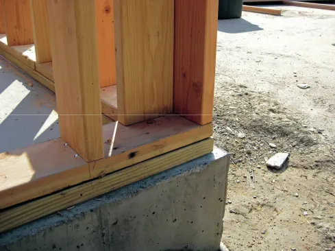 We decided to set the foam sill seal and PT 2x6 mudsills back 1 1/2 inches off the edge of the concrete
