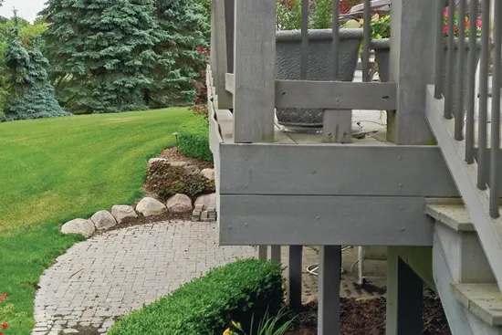 Water and debris that collect behind the fascia board can eventually cause it to pull away from the deck. Here the fascia has rippled and deformed at its top edge.


