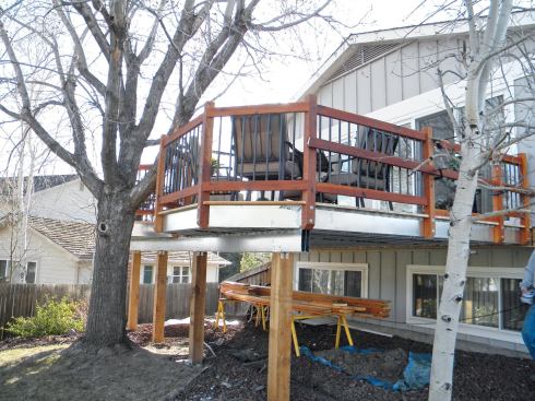 It’s simpler and cheaper to make support columns and railing posts from wood.