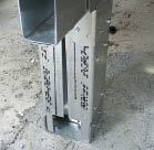 Figure 12. A short piece of track bolted to the footing serves as the post base for a steel post.