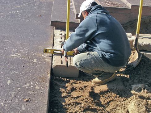 Some manufacturers recommend adding a layer of coarse sand to make leveling the first course of block easier.
