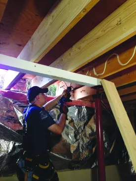 He then applied construction adhesive to the old joists.