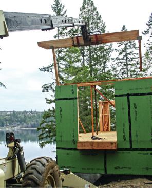A variation of this technique is to attach the support columns and hardware to the beam while it's on the ground, then lift the whole assembly into place.
