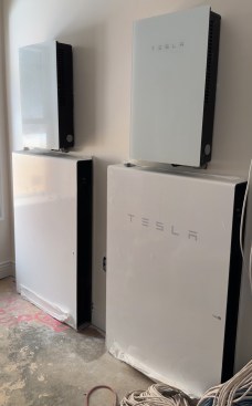 The two Tesla Powerwall backup batteries (positioned along the bottom), each with an inverter (at top).