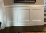 White paint finishes a traditional raised-panel wainscoting. This look is what most people think of as wainscoting but is nowhere near the only option for clients.